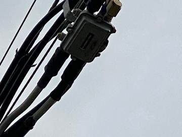 Aerial line tap and hardline cabling on the strand