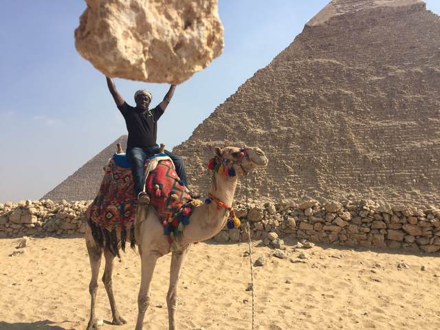 On a camel in front of the pyramids at Giza