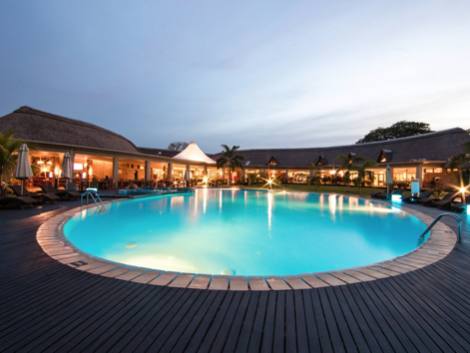 Resort pool and terrace at dusk lit by the installed LED scheme